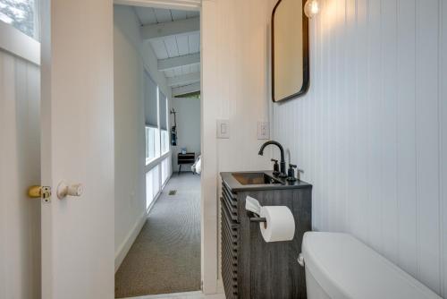 a bathroom with a sink and a toilet and a mirror at Gilford Vacation Rental with Lake Access and Mtn Views in Gilford