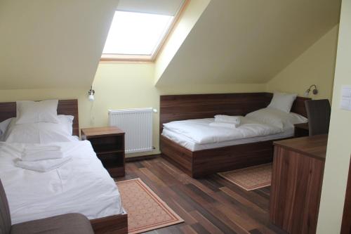 a bedroom with two beds and a window at Pótkerék Motel in Győr