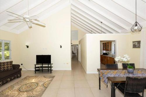 a living room with a ceiling fan and a couch at Richmond - Heroes Villa, AC, Security, Access to Pool, Playground & Private Beach - Welcome Breakfast Basket in Richmond