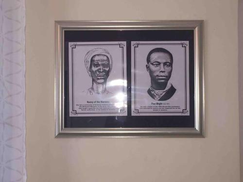 two framed pictures of two men on a wall at Richmond - Heroes Villa, AC, Security, Access to Pool, Playground & Private Beach - Welcome Breakfast Basket in Richmond