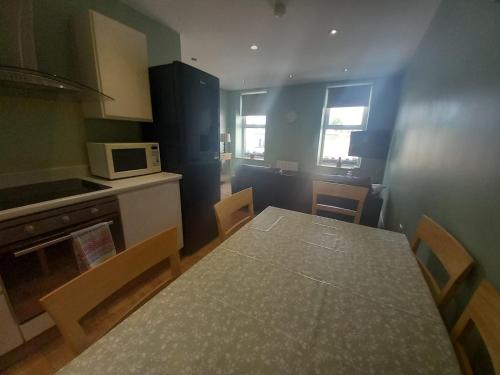 a small kitchen with a table and a microwave at Sawel view Apartments in Dungiven