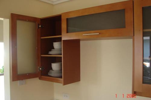 a cabinet with plates and bowls in it at Richmond - Heroes Villa, AC, Security, Access to Pool, Playground & Private Beach - Welcome Breakfast Basket in Richmond