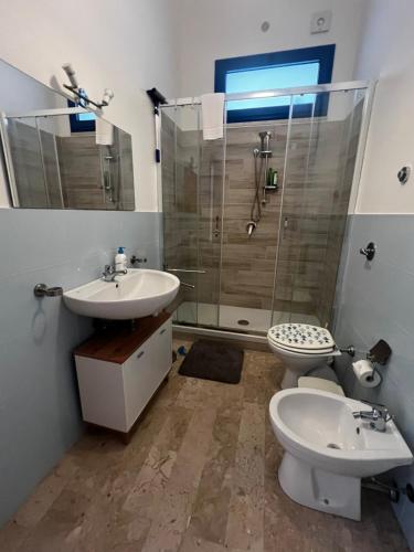 a bathroom with a toilet and a sink and a shower at A CASA di ROSA,fronte spiaggia, piscina,parcheggio in Trapani