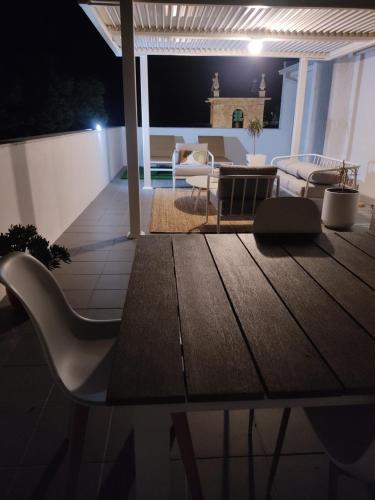 a table and chairs on a patio at night at Douro Valley Terrace Apartments in Armamar