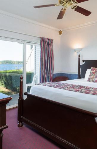 a bedroom with a bed and a large window at The Blue Heron Inn in LaPorte