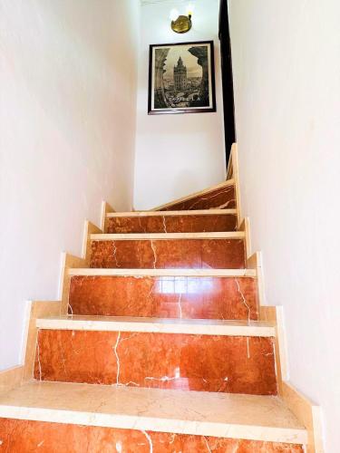 a set of stairs with a picture on the wall at Casa Juan María in Alora