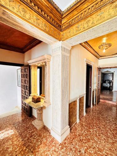 an ornate room with columns and a ceiling at Casa Juan María in Alora