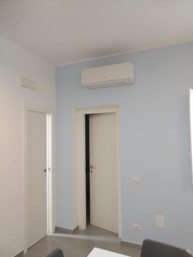 an empty room with two doors and a ceiling at LA REGGIA APARTMENTS MILAZZO in Milazzo