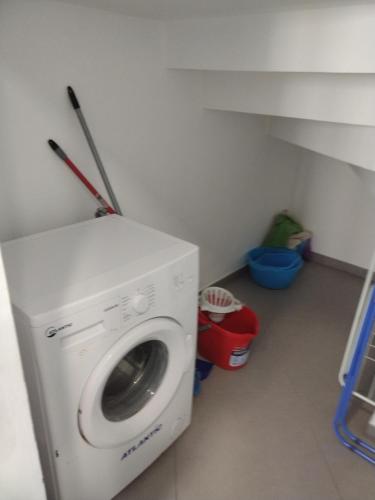 a washing machine in a small room with a staircase at LA REGGIA APARTMENTS MILAZZO in Milazzo