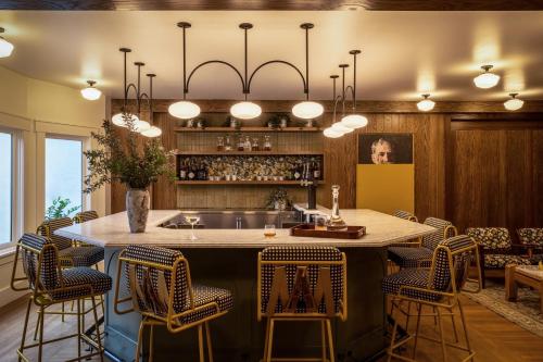 a kitchen with a large island with bar chairs at The Richland in Orange