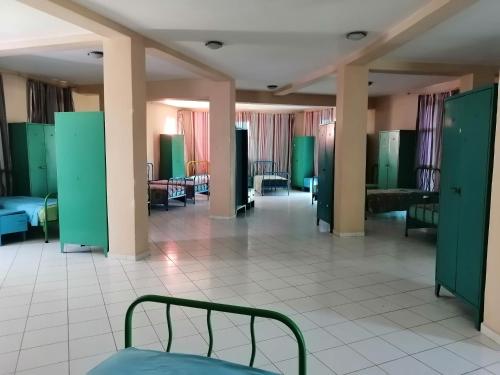 a hospital room with a bed and tables and chairs at Maison des artistes in Tangier