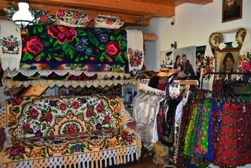 a store filled with lots of colorful fabrics and dresses at Casa Papițu in Vadu Izei