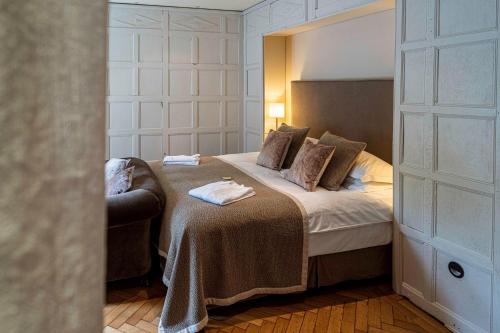 a bedroom with a large bed with a headboard at Montigo Resorts, Somerset in Shepton Mallet
