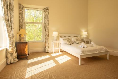 a bedroom with a bed and a window at Feith Mhor Lodge in Carrbridge