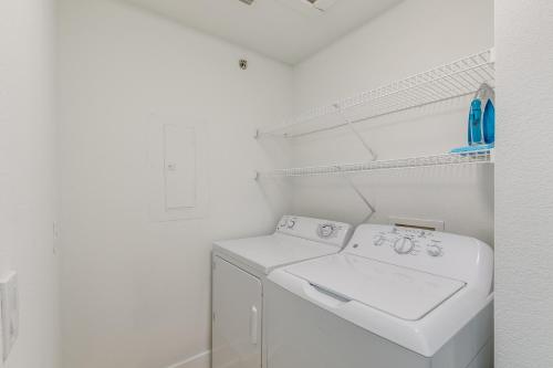 a white laundry room with a washer and dryer at One Club Gulf Shores in Gulf Shores