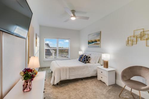 a white bedroom with a bed and a window at One Club Gulf Shores in Gulf Shores