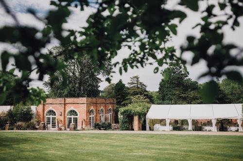 a brick building with a tent in a field at Montigo Resorts, Somerset in Shepton Mallet