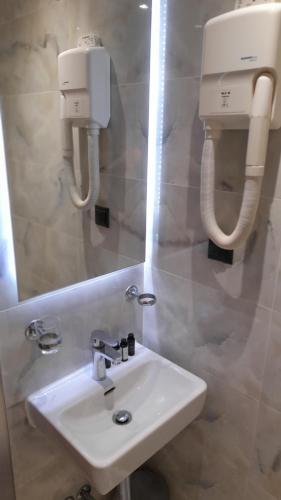a bathroom with a white sink and a mirror at Cabo Verde in Agia Triada