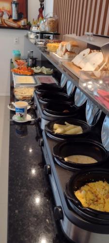 a buffet line with many plates of food at Hotel Saveiro in Recife
