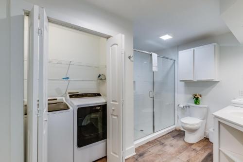 a white bathroom with a toilet and a sink at One Club Gulf Shores in Gulf Shores