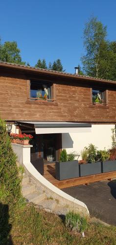 a house with a staircase in front of it at Gite de Montagne "Calluna" 1 ou 2 pers in Xonrupt-Longemer