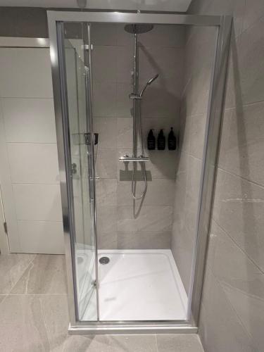 a shower with a glass enclosure in a bathroom at seaview 87 in Portrush