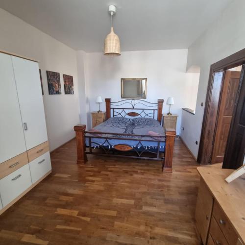 a bedroom with a bed and a wooden floor at Vila Lucia - Apartmán 3 in Plzeň