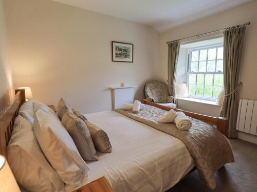 a bedroom with a large bed with a window at Slaters Rest in Chapel Stile