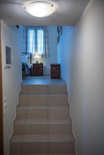 a stairway leading up to a bedroom with a window at Kouremenos Beach House West in Sitia