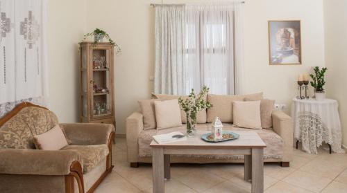 a living room with a couch and a table at Kouremenos Beach House West in Sitia