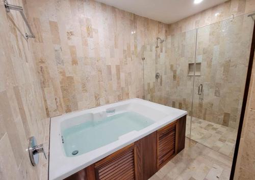 a bathroom with a bath tub and a shower at Real Cocula in Cocula