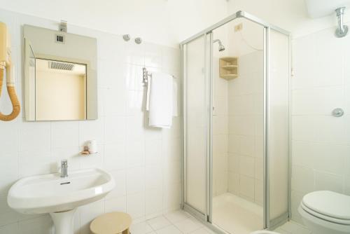 a bathroom with a shower and a sink and a toilet at Hotel La Fonte a 300m uscita A14 Pescara Nord in Citta' Sant'Angelo