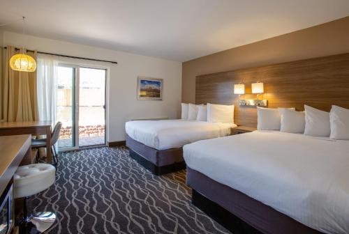 a hotel room with two beds and a window at Dreamcatcher Inn of Sedona in Sedona
