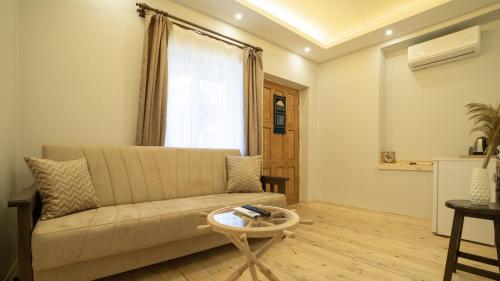 a living room with a couch and a table at My Home Hotel Gulluk in Antalya