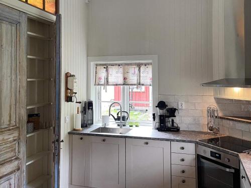 a kitchen with a sink and a window at 4 person holiday home in ALLINGSÅS, SVERIGE in Hjälmared