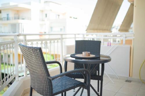 two chairs and a table on a balcony at Diana’s Place in Alexandroupoli