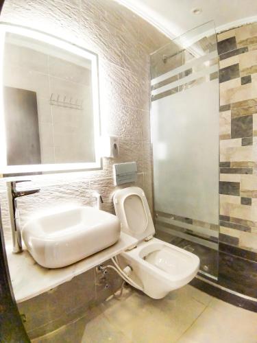 a bathroom with a toilet and a sink at Tourist Palace Hotel in Cairo