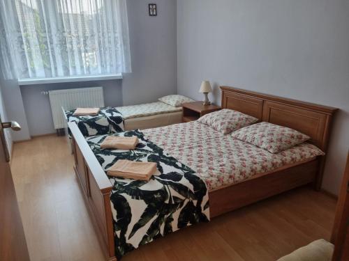 a bedroom with a bed with a comforter on it at Apartamenty Anna in Mosty