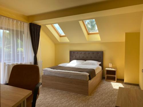 a bedroom with a large bed with skylights at BELLESTAY in Braşov