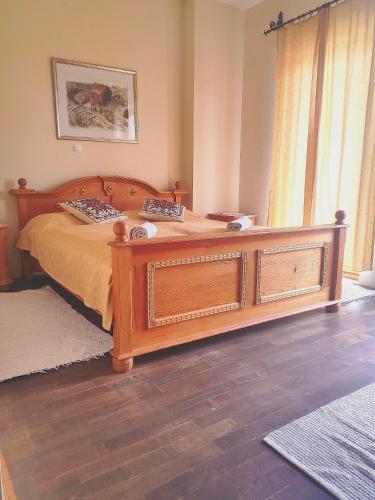 a bedroom with a wooden bed and a window at Turistična kmetija HLEBEC in Kog