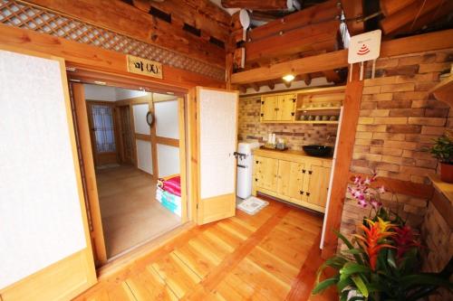 a large kitchen with wooden floors and wooden walls at Gawondang in Jeonju