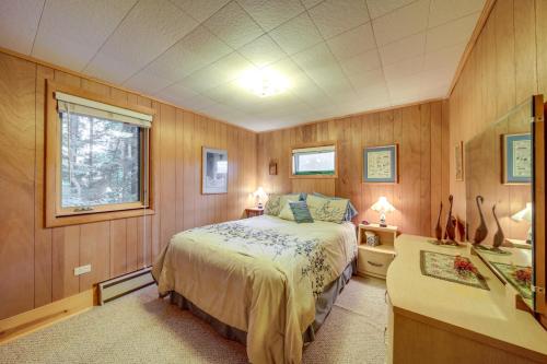 a bedroom with a bed and a desk and a window at Waterfront Newport Vacation Rental on Sacheen Lake in Newport