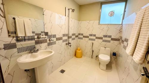 a bathroom with a sink and a toilet at Desert One Hotel Skardu in Skardu