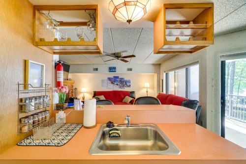 a kitchen with a sink and a living room at Lakefront Condo with Pool Access-1min to Big Boulder! in Lake Harmony