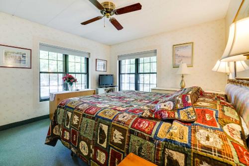 a bedroom with a bed with a colorful quilt at Lakefront Condo Pool Access Less Than 1 Mi to Big Boulder in Lake Harmony