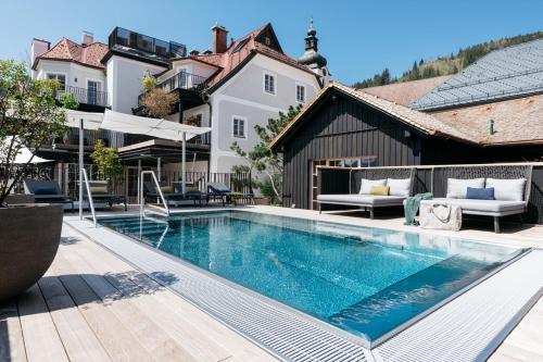 a swimming pool in the backyard of a house at Refugium Lunz in Lunz am See