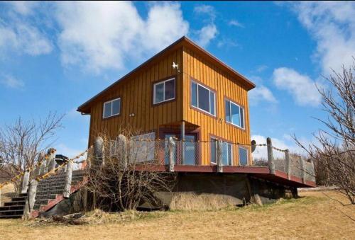 a house on the side of a hill with stairs at The Lookout - ALASKA SIZED VIEWS in Homer