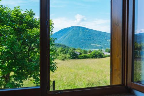 a window with a view of a mountain at La Veranda Alpago in Pieve dʼAlpago