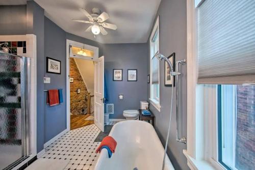 a bathroom with a tub and a toilet and a ceiling fan at Contemporary Townhome in Midtown Harrisburg! in Harrisburg
