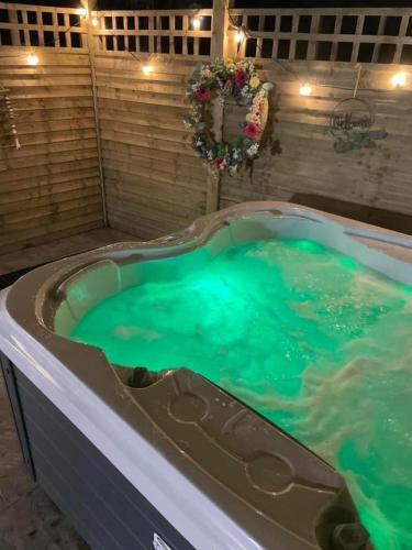 a hot tub with green water in a room at Paddock Pod - Sleeps 4 & Roofed Over Private Hot Tub & NEW SAUNA in Burnfoot